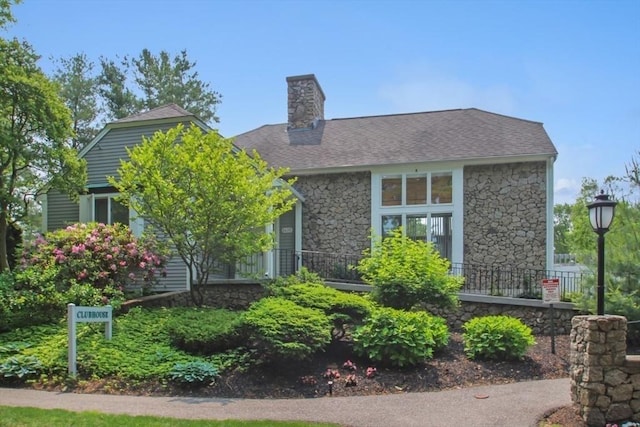 1504 Huckleberry Ct Unit 1504, Peabody, MA 01960 - view of front of property with stone siding, a chimney, and a shingled roof