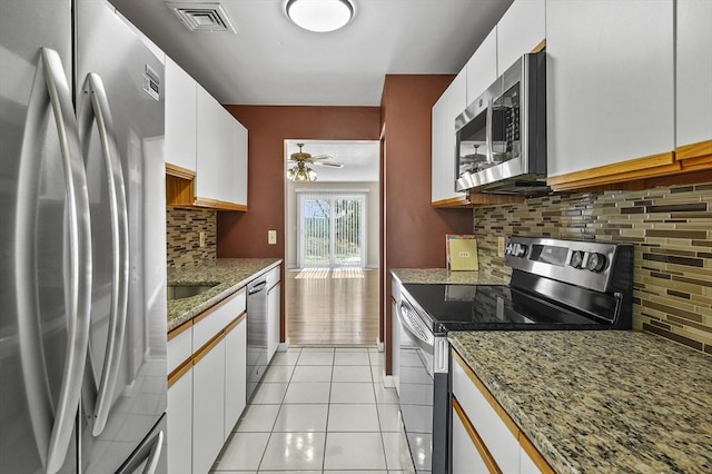 kitchen with light tile patterned floors, visible vents, appliances with stainless steel finishes, and white cabinetry