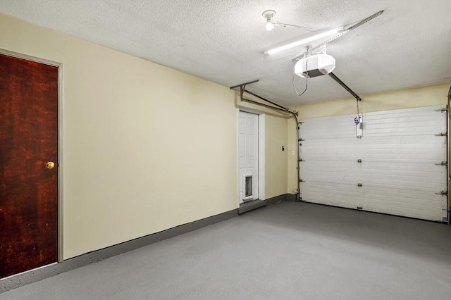 garage featuring a garage door opener and baseboards