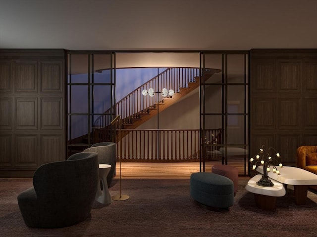 sitting room featuring a high ceiling and stairway