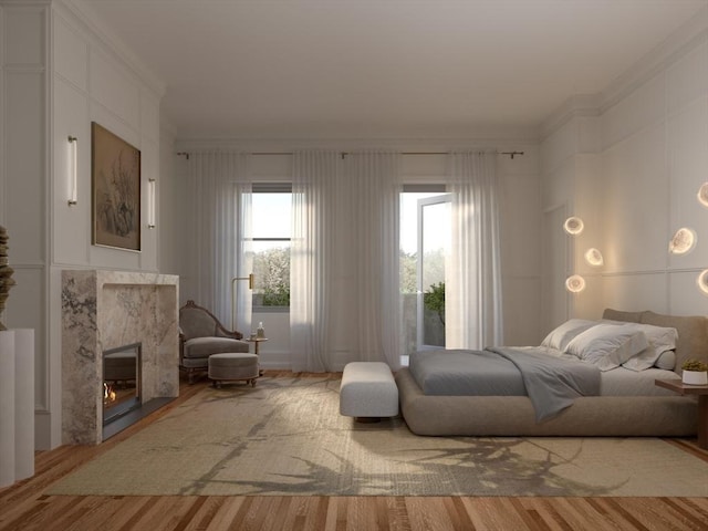 interior space featuring a fireplace, wood finished floors, and crown molding