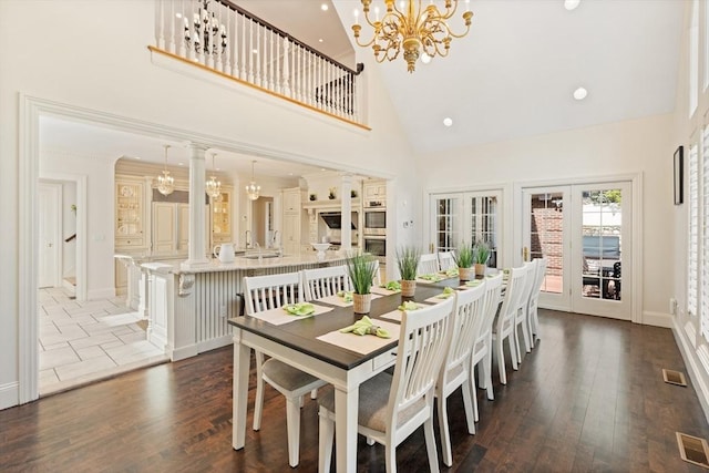 dining area featuring high vaulted ceiling, a chandelier, french doors, wood finished floors, and visible vents