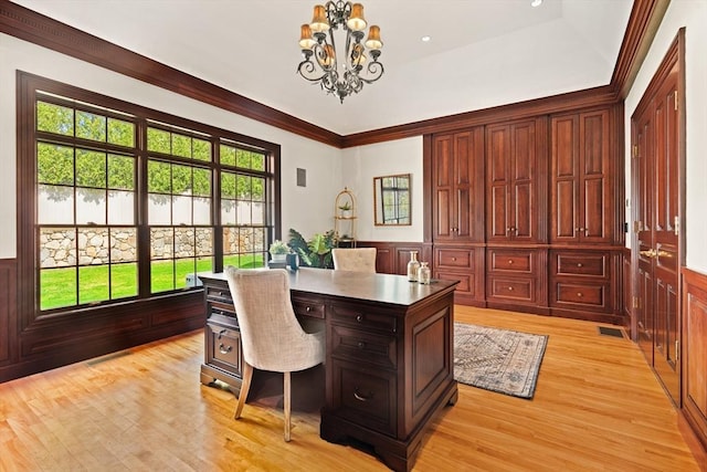 office area with visible vents, wainscoting, light wood-type flooring, an inviting chandelier, and ornamental molding