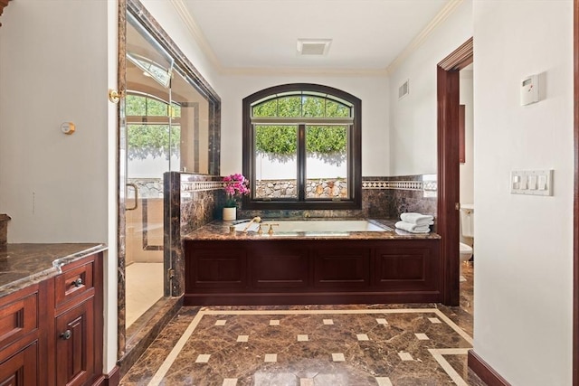 bathroom with visible vents, ornamental molding, a bath, and toilet