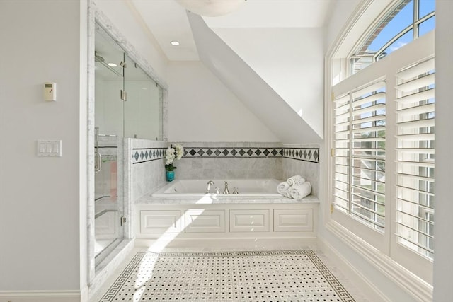 bathroom with a shower stall and a garden tub