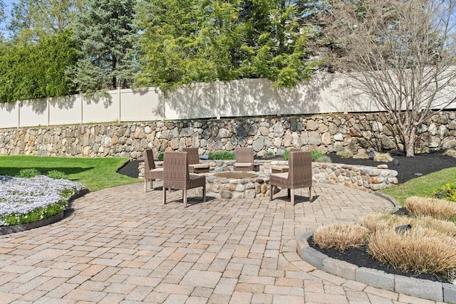 view of patio / terrace with fence and an outdoor fire pit