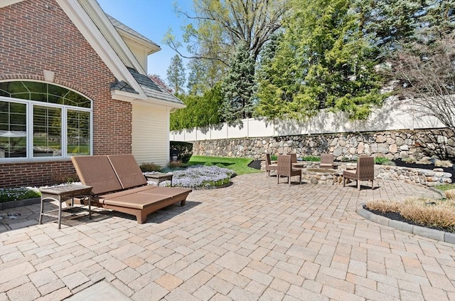 view of patio / terrace with fence and a fire pit