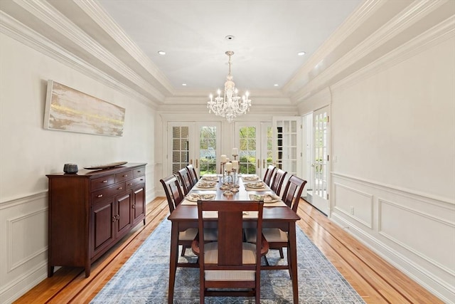 dining area with french doors, a decorative wall, and a wealth of natural light
