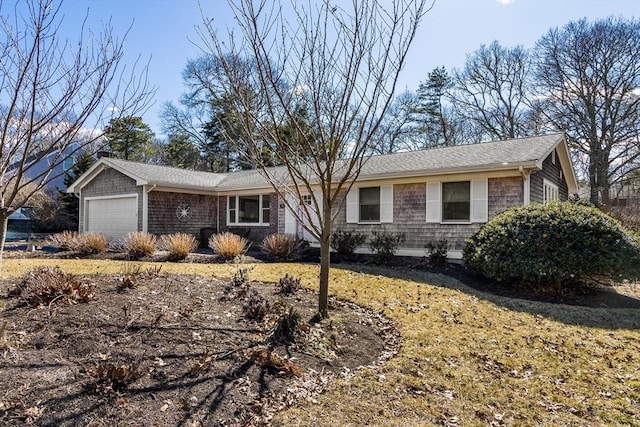 ranch-style home with an attached garage and a shingled roof