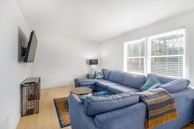 living room featuring light wood-style flooring and baseboards