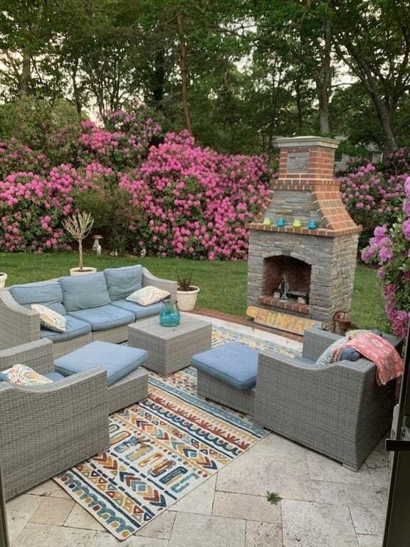 view of patio featuring an outdoor living space with a fireplace