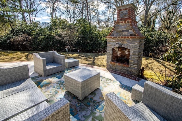 view of patio with an outdoor living space with a fireplace