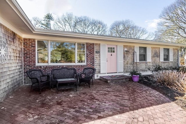 doorway to property featuring an outdoor living space and a patio