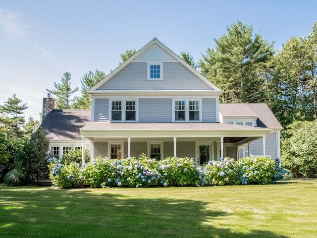 view of front of home with a front lawn and a chimney