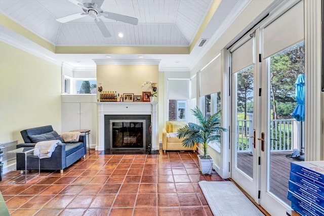 sunroom with a raised ceiling, wooden ceiling, and ceiling fan