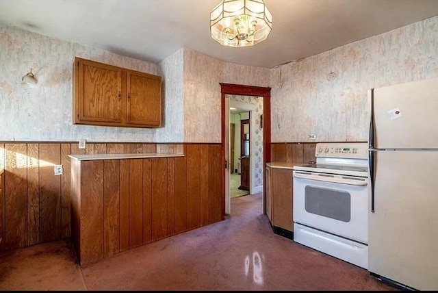 2 Leicester St, Oxford, MA 01537 - kitchen with brown cabinetry, freestanding refrigerator, white electric range oven, a wainscoted wall, and carpet flooring