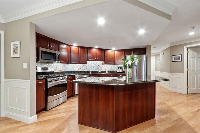 4 Sterling Hill Ln Unit 424, Exeter, NH 03833 - kitchen with stainless steel appliances, a decorative wall, light wood-style flooring, wainscoting, and a kitchen island