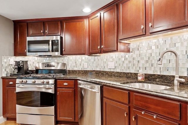 4 Sterling Hill Ln Unit 424, Exeter, NH 03833 - kitchen featuring appliances with stainless steel finishes, dark stone counters, and backsplash