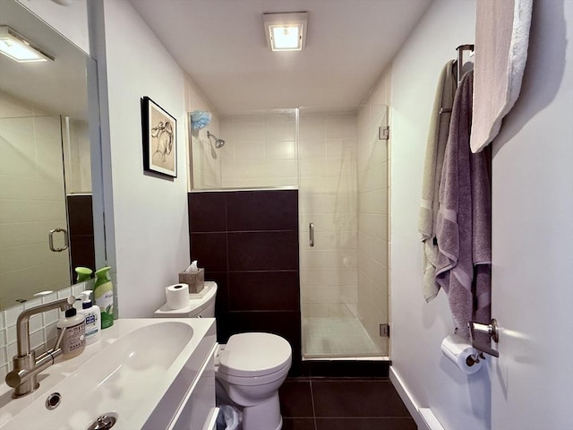 full bath with tile patterned floors, a stall shower, toilet, and vanity