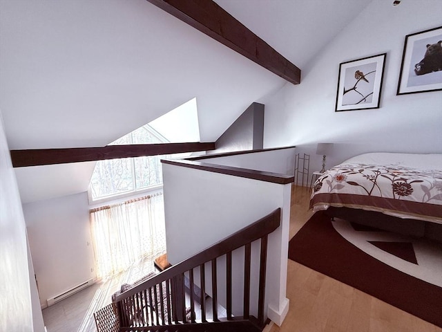 bedroom featuring lofted ceiling with beams, a baseboard radiator, and wood finished floors