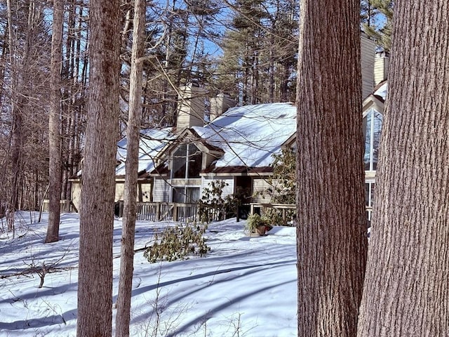 snowy yard featuring a wooden deck