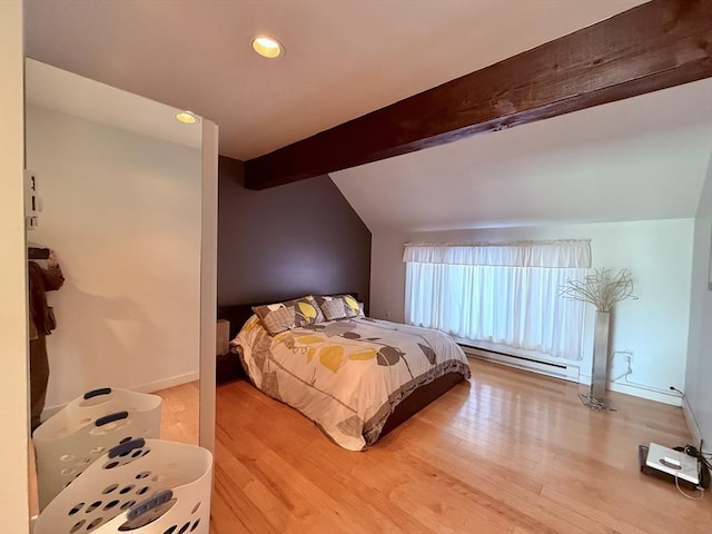 bedroom featuring a baseboard heating unit, lofted ceiling with beams, wood finished floors, and baseboards