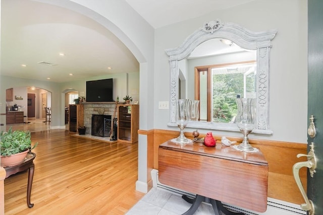 35 Williams St, Lincoln, RI 02865 - foyer with wood finished floors, a fireplace, arched walkways, a baseboard heating unit, and recessed lighting