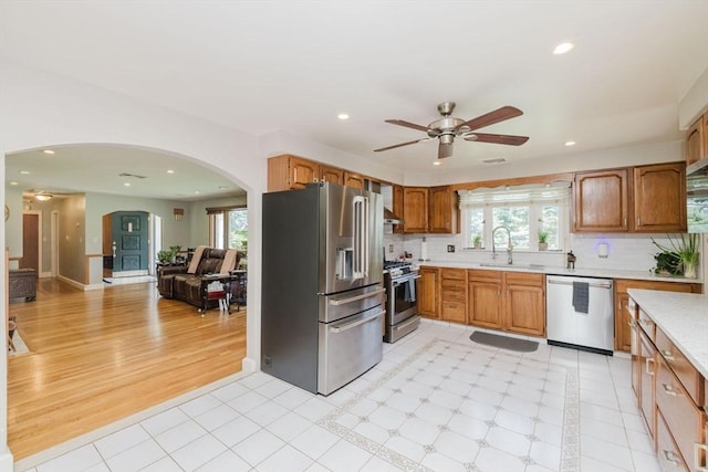 35 Williams St, Lincoln, RI 02865 - kitchen with stainless steel appliances, light countertops, arched walkways, a ceiling fan, and a sink