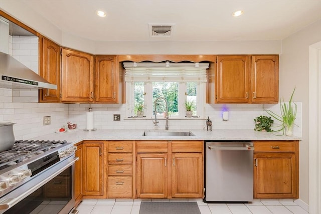 35 Williams St, Lincoln, RI 02865 - kitchen featuring stainless steel appliances, wall chimney range hood, a sink, decorative backsplash, and brown cabinetry