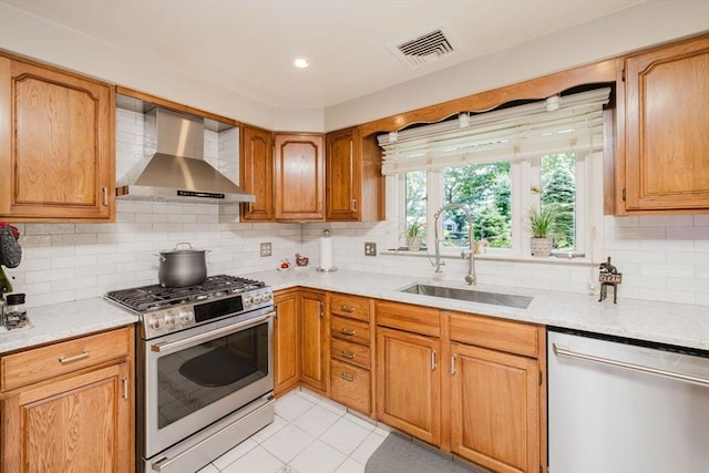 35 Williams St, Lincoln, RI 02865 - kitchen featuring stainless steel appliances, wall chimney range hood, a sink, tasteful backsplash, and light tile patterned floors