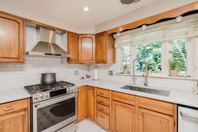 35 Williams St, Lincoln, RI 02865 - kitchen with stainless steel range with gas stovetop, wall chimney exhaust hood, a sink, dishwasher, and decorative backsplash