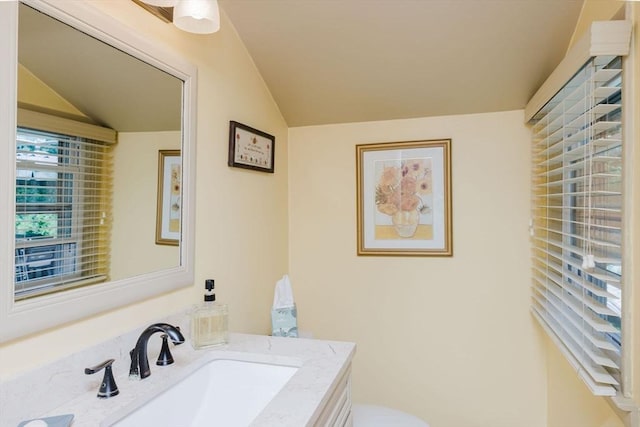35 Williams St, Lincoln, RI 02865 - half bathroom with lofted ceiling, vanity, and toilet