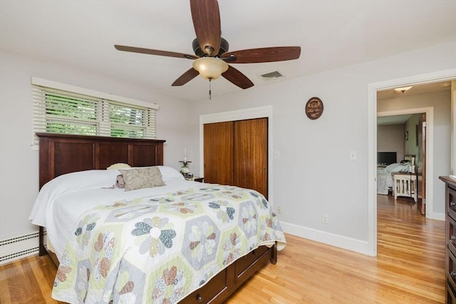 35 Williams St, Lincoln, RI 02865 - bedroom featuring light wood-style floors, baseboards, a closet, a baseboard radiator, and a ceiling fan