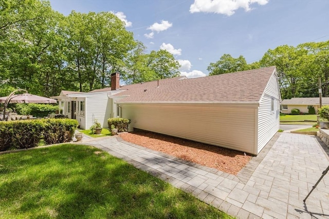 35 Williams St, Lincoln, RI 02865 - back of property featuring roof with shingles, a lawn, and a chimney