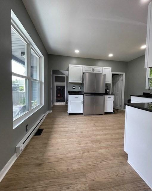 36 Circle St, Templeton, MA 01436 - kitchen featuring freestanding refrigerator, dark countertops, white cabinets, light wood-type flooring, and a baseboard heating unit