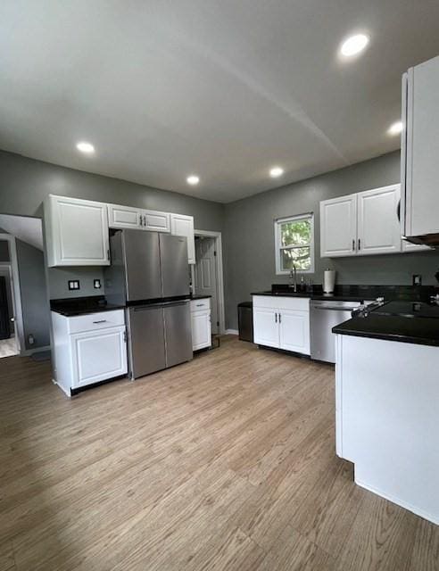 36 Circle St, Templeton, MA 01436 - kitchen featuring appliances with stainless steel finishes, dark countertops, white cabinets, light wood-style flooring, and a sink