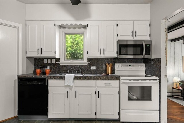 15 Newland Rd, Arlington, MA 02474 - kitchen featuring stainless steel microwave, white range with electric cooktop, black dishwasher, dark countertops, and white cabinetry