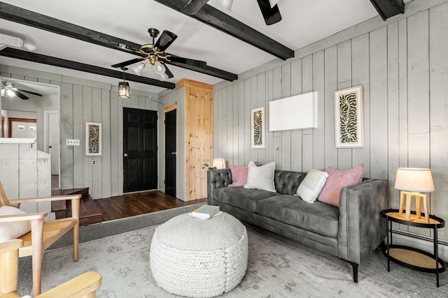 15 Newland Rd, Arlington, MA 02474 - living room with a ceiling fan, beamed ceiling, wood walls, carpet, and a baseboard radiator