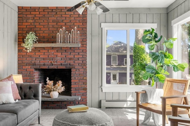 15 Newland Rd, Arlington, MA 02474 - carpeted living area featuring a baseboard radiator, a ceiling fan, wood walls, and a fireplace
