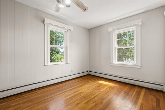 15 Newland Rd, Arlington, MA 02474 - spare room featuring wood finished floors, ceiling fan, and a baseboard heating unit