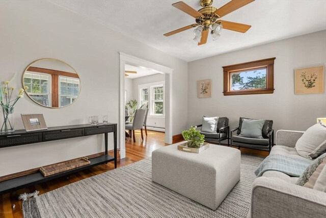 15 Newland Rd, Arlington, MA 02474 - living room with wood finished floors, ceiling fan, and baseboard heating