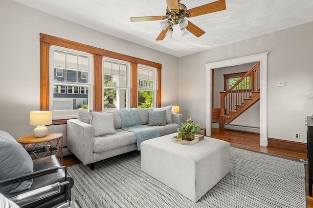 15 Newland Rd, Arlington, MA 02474 - living area featuring healthy amount of natural light, wood finished floors, a baseboard radiator, and stairs