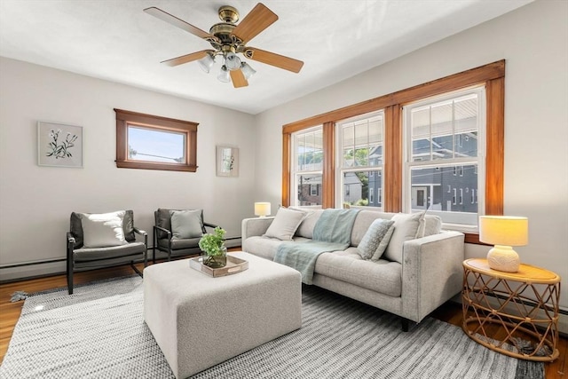 15 Newland Rd, Arlington, MA 02474 - living room with light wood finished floors, a ceiling fan, and a baseboard heating unit
