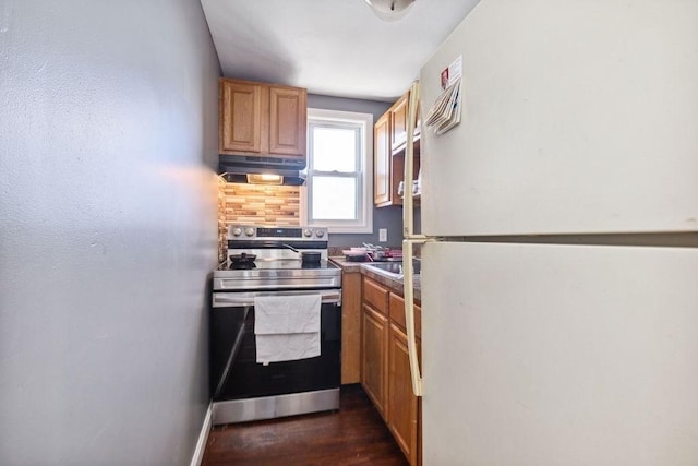 kitchen with electric range, dark wood-type flooring, and white fridge