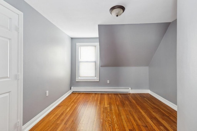 bonus room with baseboard heating and dark hardwood / wood-style flooring