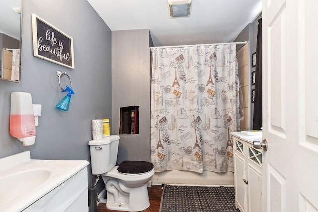 full bathroom featuring vanity, toilet, and shower / bath combination with curtain