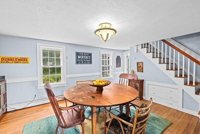 146 Chief Justic Cushing Hwy, Scituate, MA 02066 - dining room featuring stairway, hardwood / wood-style flooring, a baseboard heating unit, and a textured ceiling
