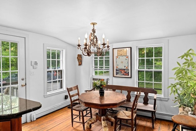 146 Chief Justic Cushing Hwy, Scituate, MA 02066 - dining space featuring baseboard heating, light wood-style flooring, a chandelier, and vaulted ceiling