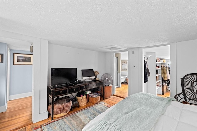 146 Chief Justic Cushing Hwy, Scituate, MA 02066 - bedroom with a textured ceiling, wood finished floors, a spacious closet, and a closet