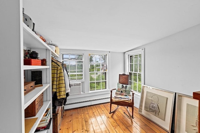 146 Chief Justic Cushing Hwy, Scituate, MA 02066 - sitting room with a baseboard heating unit, light wood-type flooring, and cooling unit
